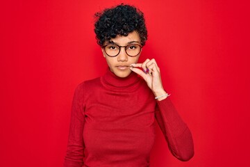 Young beautiful african american afro woman wearing turtleneck sweater and glasses mouth and lips...