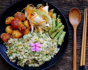 plate of mixed fried rice with tofu pie and vegetables for nutrition vegetarian meal, Vietnamese vegan food at lunch time