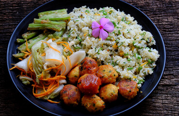 plate of mixed fried rice with tofu pie and vegetables for nutrition vegetarian meal, Vietnamese vegan food at lunch time