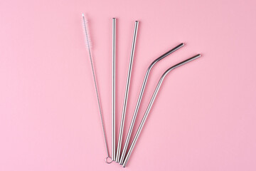 Reusable steel straws on pink background. Zero waste concept.