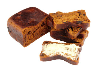 Malt fruit loaf with butter spread on one slice isolated in a white background