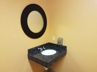 mirror and counter with sink in bathroom or restroom