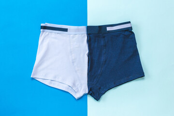 Two men's underpants on a two-color background.