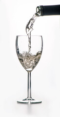 white wine pouring into a glass