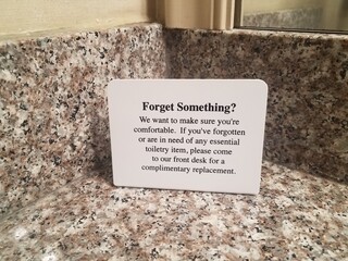 forget something sign on bathroom counter in hotel