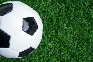 Fototapeta na wymiar Traditional soccer ball or football on soccer football field. Copy space for text 