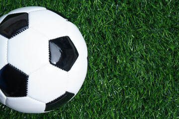 Fototapeta na wymiar Traditional soccer ball or football on soccer football field. Copy space for text 