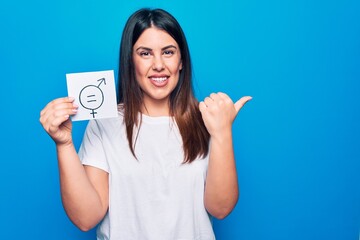 Young beautiful woman asking for sex discrimination holding paper with gender equality concept...