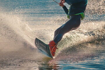 Wakeboarder making tricks on sunset