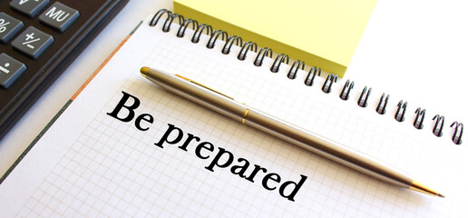 In the notebook there is an inscription. Office table. The calculator. A pen.