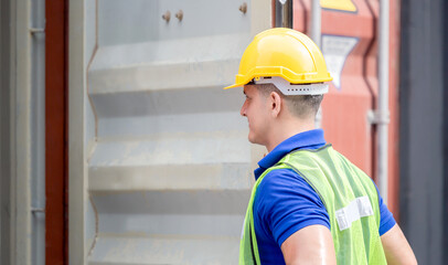 Engineer worker man in hardhat and safety vest checking containers box from cargo