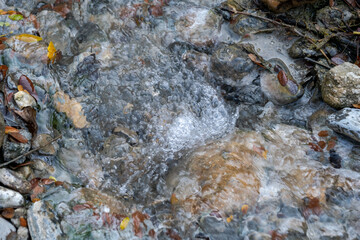 Hot spring water flowing on the rock in a morning