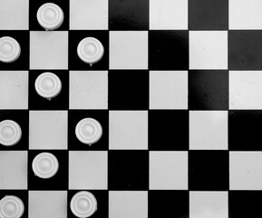 Board intelligent game - checkers. Black white photo top view     