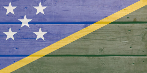 Solomon islands flag painted on wood plank background. Brushed natural light knotted wooden board...