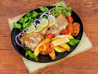 Baked ocean perches with vegetables on rustic table, top view