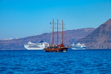 Modern Cruise Ships and Old Sailing Ship off the Coast of Santorini