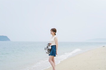 Fototapeta na wymiar 海辺を散策する女性