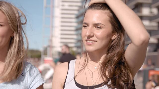 A happy teenage girl walking in the harbour.