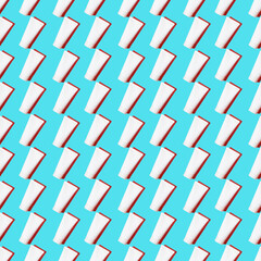 Seamless pattern of white cream tubes of the blue background