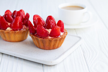 Strawberry shortcake pies strawberries tartlets with custard on white wooden background