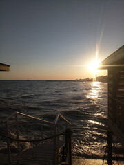 sunset at sea through the gazebo on the beach