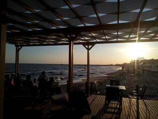 sunset at sea through the gazebo on the beach