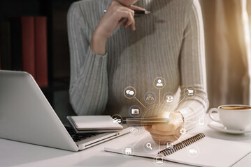 Woman using a credit card and digital laptop in home office.
