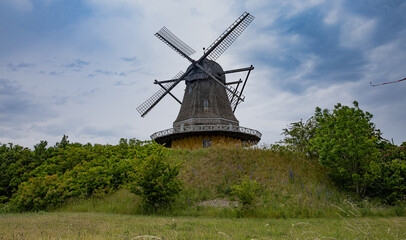 MIll on the hilltop with blue sky and clouds