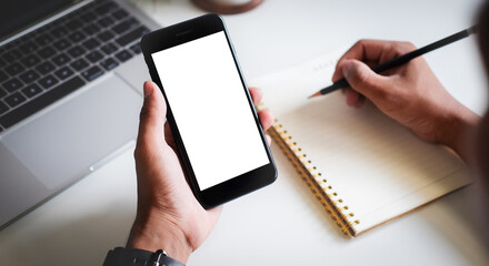 Mock up smartphone of hand holding black mobile phone with blank white screen.