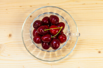 Ripe sweet cherries on a wooden background.