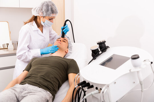 Man getting face ultrasound lifting procedure