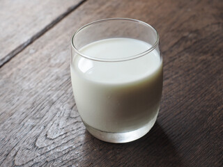 Glass of milk on wooden table