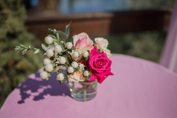 a bouquet of flowers on a table in a restaurant