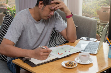 A young businessman sitting at a computer desk, Work from home and social concept.