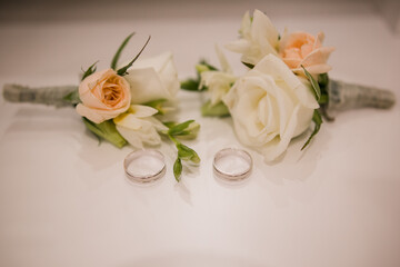 wedding rings with a bouquet of the bride