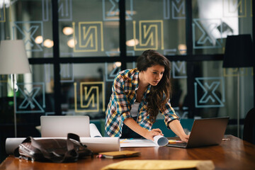 Beautiful businesswoman in office. Young architect workin on project.