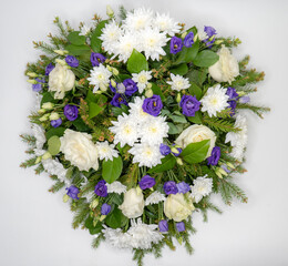 Colorful wreath flower arrangement. Floral concept isolated on white background. Funeral flowers.