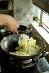 A chef is cooking cabbage