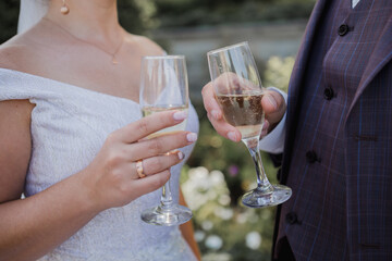 glasses with champagne in the hands at wedding