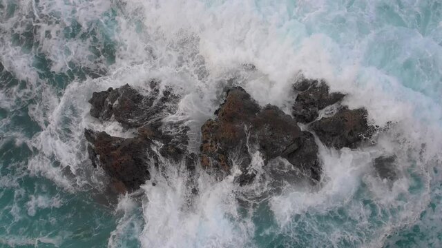 Aerial: Surf breaking in beautiful turquoise waters, New Zealand