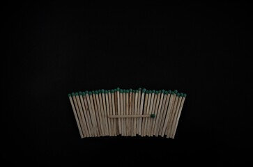 matches lined up in a row on a black background