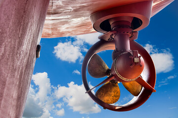 Ship repair in shipyard Low angle view of Propeller for vessel in floating dry dock on blue sky background.