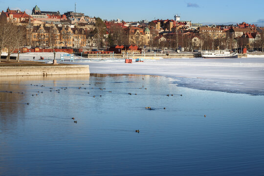 Melting ice on the shore of the lake on the background of &Ouml;stersund