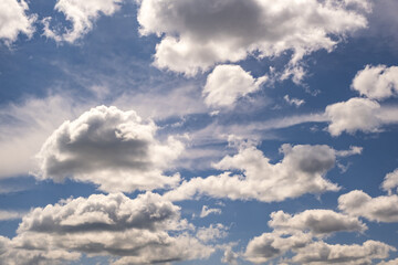 Blue sky background with big tiny stratus cirrus striped clouds