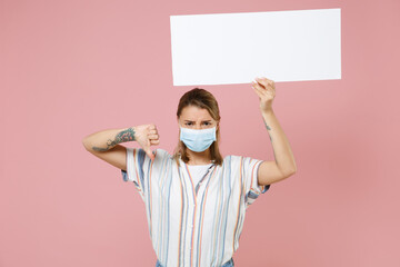 Young girl in casual striped shirt sterile face mask isolated on pink background. Epidemic pandemic...