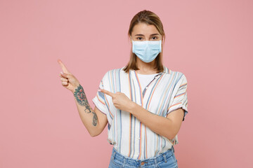 Young blonde woman girl in casual striped shirt sterile face mask isolated on pink background....