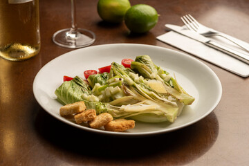 salad half cut lettuce dressing wine glass and limes