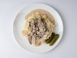 Beef stroganoff with crushed potatoes on a plate. Tasty healthy food