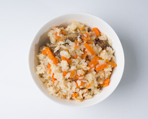 Pilaf in a round white bowl. Asian traditional dish