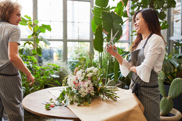 Florists tying flowers for a bunch of flowers